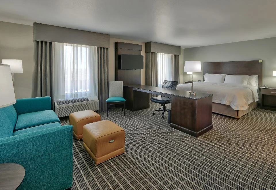 Guest room with seating area at Hampton Inn and Suites Albuquerque Airport